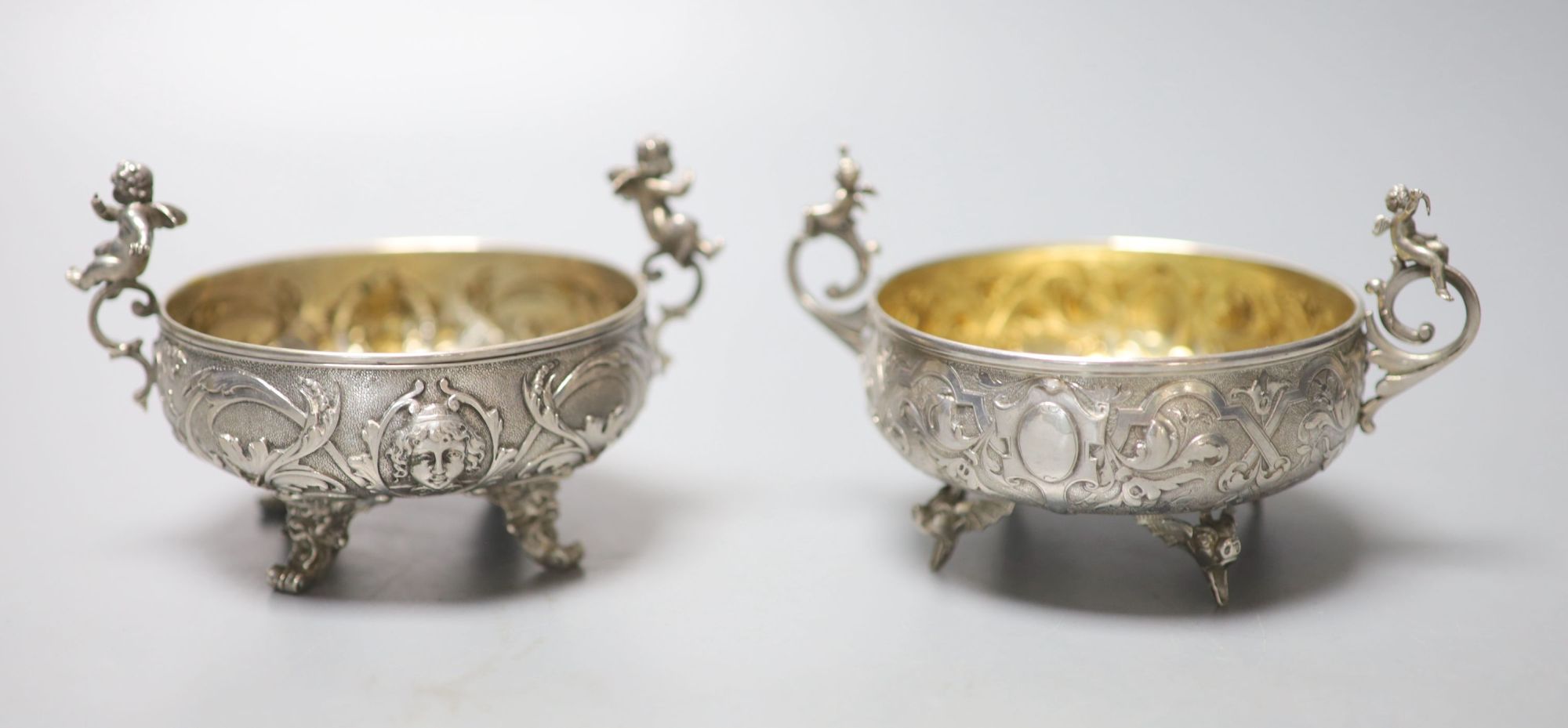 A pair of Italian white metal two handled sweetmeat bowls, by G Accarisi, with figural handles, dia. 85mm, 8oz.